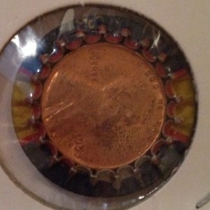A 1953-D Lincoln Cent is "trapped" inside this Dad's Root beer bottle cap