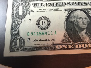 Close up of the Series 2013 $1 FRN. Note that the serial number begins with “911”